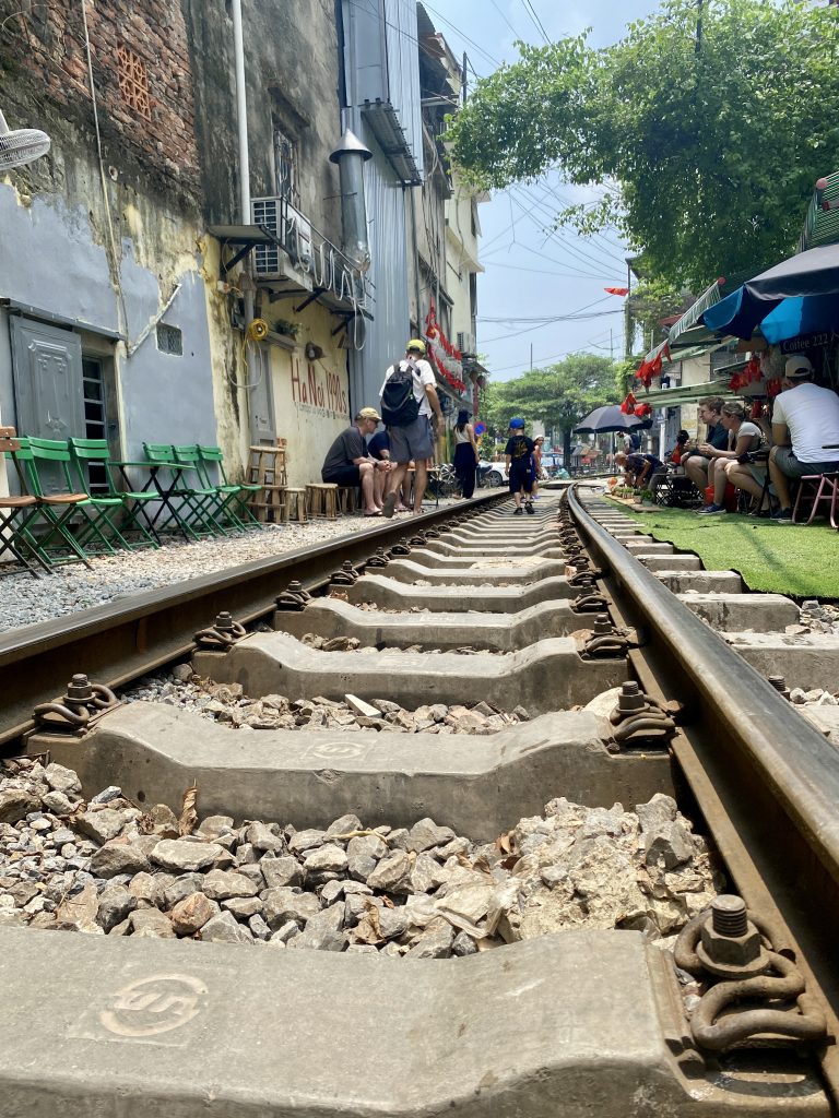Train tracks running through the narrow alley of Hanoi’s bustling Train Street.